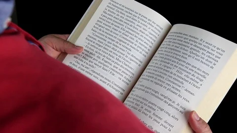 Closeup of a middle age man reading a book and turning pages at his office. Stock Footage 111035355