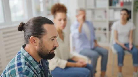 Closeup of middle-aged man sharing his issues with support group members Stock Footage 232295819