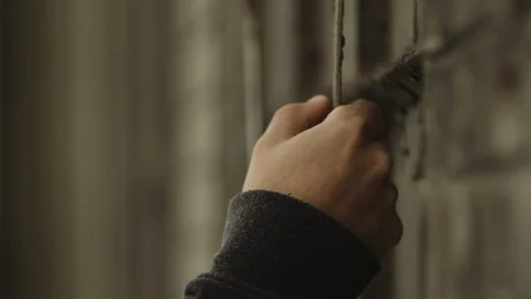 Closeup of a  millennial male's hand on a rusty pipe Stock Footage 88051217