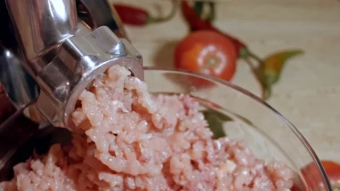 Closeup of minced meat is scrolled through a meat grinder sieve. Meat grinder Stock Footage 143664654