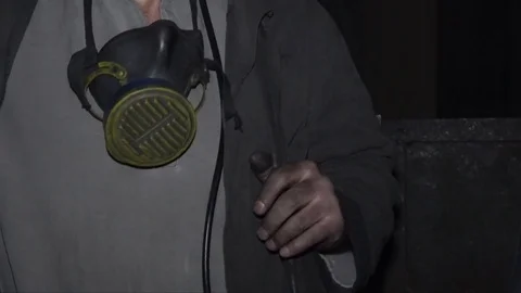 Closeup of a miner in an elevator cage descends into a mine Stock Footage 83256802