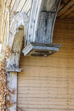 Closeup of a missing columns on the front porch of an abandoned house. Stock Photos