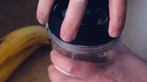 Closeup mixer lid screwed onto breakfast smoothie cup, healthy eating Vídeo Stock 315089226