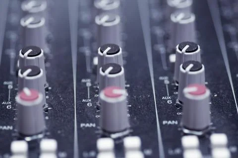 Closeup mixing faders and knobs as seen from above side angle, artistic studio Stock Photos