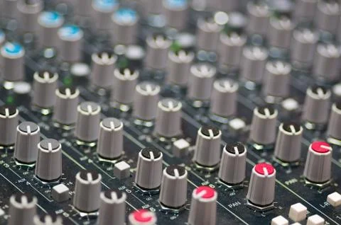 Closeup mixing faders and knobs as seen from above side angle, artistic studio Stock Photos