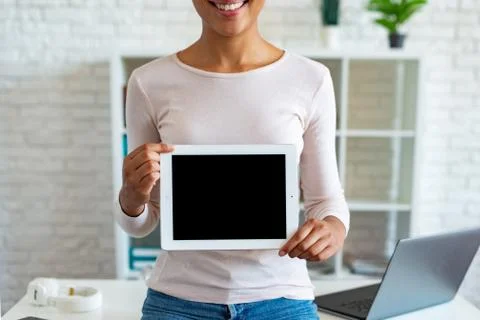 Closeup mockup image of black empty blank screen of tablet in the female hand Stock Photos