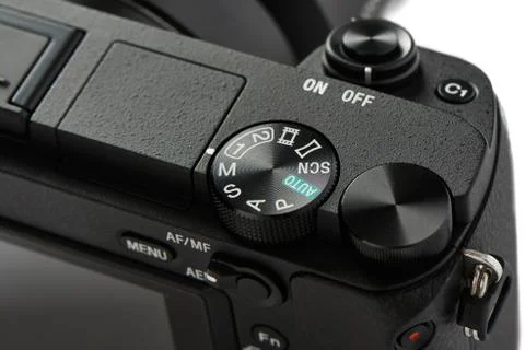 Closeup of mode selection dial on a Mirrorless Camera, isolated on white. Stock Photos