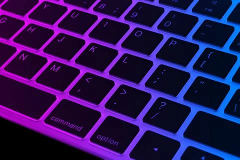 Closeup of a modern computer keyboard keys in pink and blue tones. Close up.. Foto stock