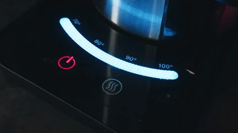A CloseUp of a Modern Induction Cooktops Temperature Control Interface for Vídeos de archivo 305080004