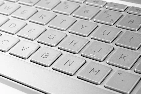Closeup of a modern silver computer keyboard keys. Close up view of a busin.. Stock Photos