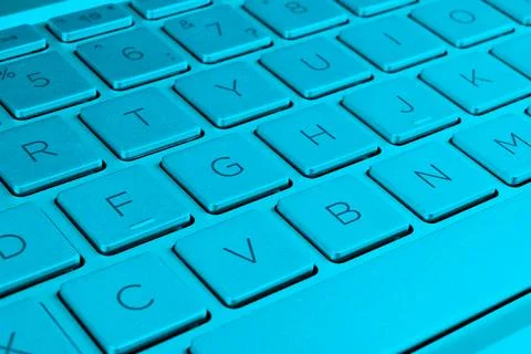 Closeup of a modern silver laptop computer keyboard. Laptop keyboard. Detai.. Stock Photos