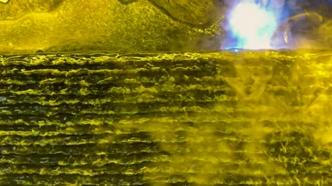 Closeup of molten metal surface with glowing heat and intricate textures in.. Vidéo 339296145