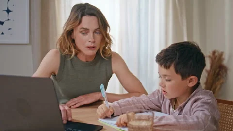 Closeup mom teaching son doing homework together in living room. Woman and child Video stock 278176980