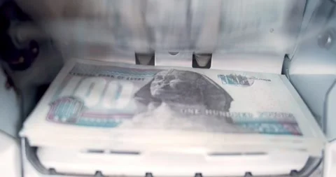 Closeup of Money Counting Machine Counting 100 Egyptian Pounds Cash Notes Stock Footage 317925399