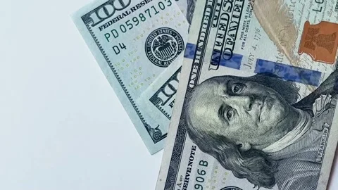 Closeup money falls on white table. Face of USA President. Dollars cover screen Stock Footage 263687171