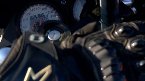 Closeup of a motorcycle biker, which are a stylish biker gloves next to the Stock Footage 75558212