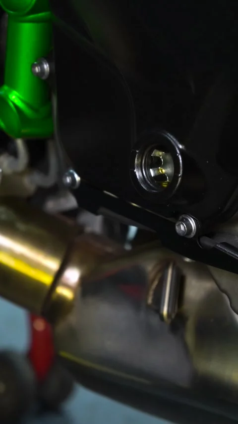 Closeup of motorcycle engine with green exhaust pipe Stock Footage 271484789