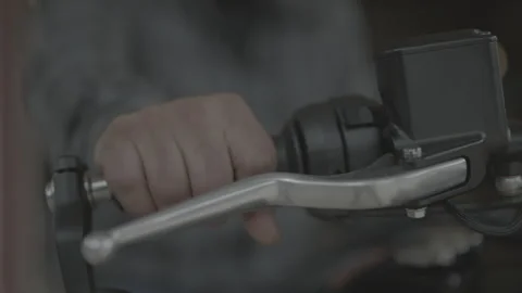 Closeup of motorcycle handlebar with man's hand revving engine Stock Footage 323476449