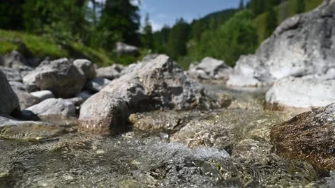 Closeup of a mountain stream in the alps (slow motion) Video stock 260845025