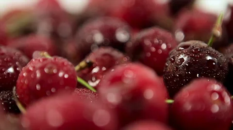 Closeup of a movement in a circle. de-focused scene. ripe cherries with drops of Stock Footage 61218433
