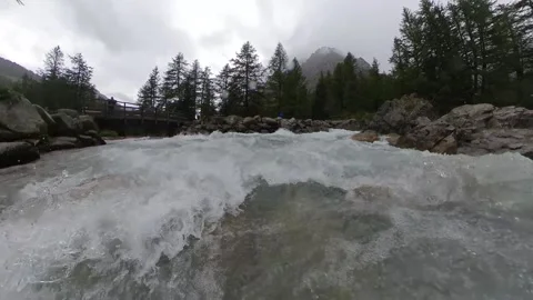 Closeup moving view of an alpine stream on a rainy summer day Stock Footage 137394792