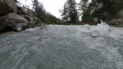 Closeup moving view of an alpine stream with a bridge on a rainy summer day Stock Footage 137395166