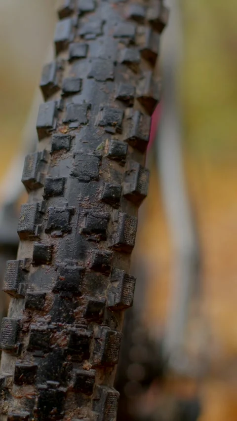 Closeup of muddy tire with textured knobs during rough terrain traversal Stock Footage 324609666
