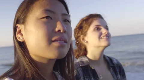Closeup Of Multiethnic Teen Girls Looking Up With Wonder At Sky, On The Beach Stock Footage