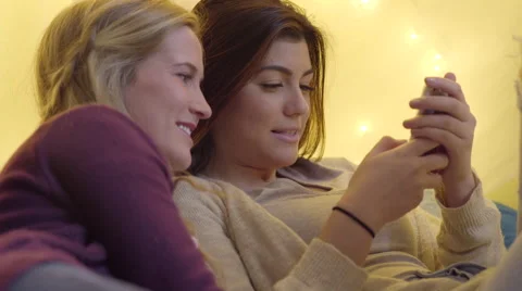 Closeup Of Multiethnic Teens Looking At A Smart Phone Together Video stock 59106781