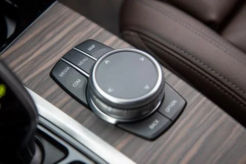 Closeup of multimedia system control buttons on a wood panel in a modern premium Stock Photos