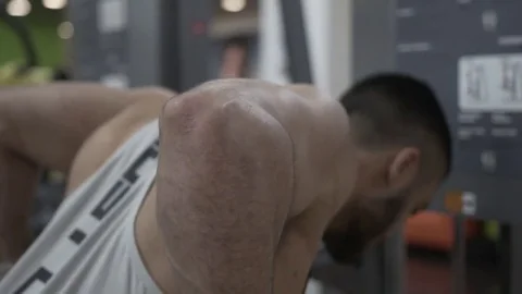 Closeup of Muscular Man Doing Triceps Exercise on Parallel Bars in Gym. Stock-Footage 77300051