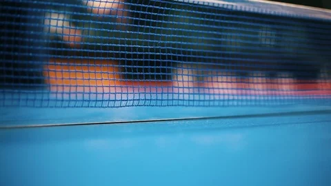 Closeup of net on blue table for ping-pong. Blurred person playing table tennis. Stock Footage 103112080