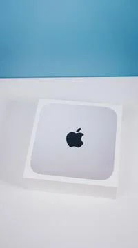 Closeup of new Apple Mac Mini m1 on white table and blue background. Russia Stock Photos