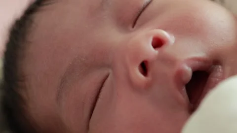 Closeup of a newborn baby sleeping on the bed Stock Footage 325561353