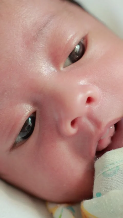 Closeup of a newborn baby sleeping on the bed Stock Footage 325561453