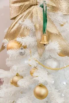 Closeup of a nice Christmas tree decorated with golden balls and a bell on a  Stock Photos