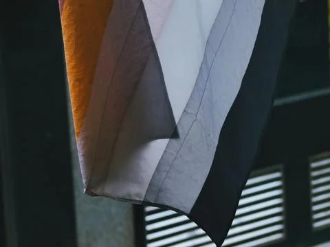Closeup of a non-binary flag hanging from a wall Stock Photos