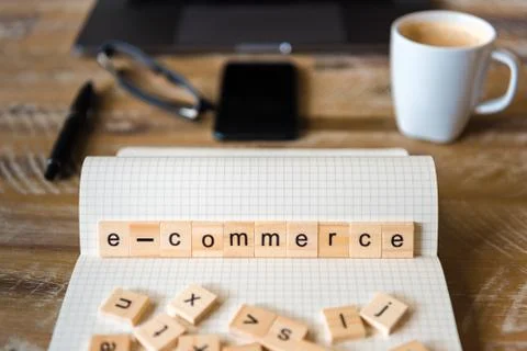 Closeup on notebook over wood table background, focus on wooden blocks Stock Photos