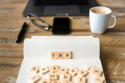Closeup on notebook over wood table background, focus on wooden blocks Stock Photos