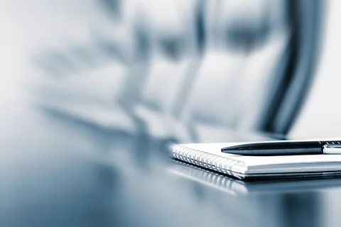 Closeup of notepad kept on table in empty room with motion blur effect Stock Photos