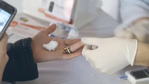 Closeup of nurse hands doing finger blood testing Stock Footage 82754948