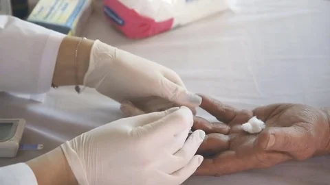 Closeup of nurse hands doing finger blood testing Video stock 82754982