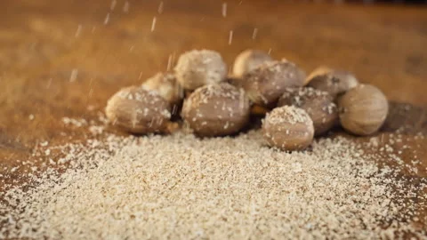 Closeup of nutmeg being freshly shredded for sauce Stock Footage 325845494