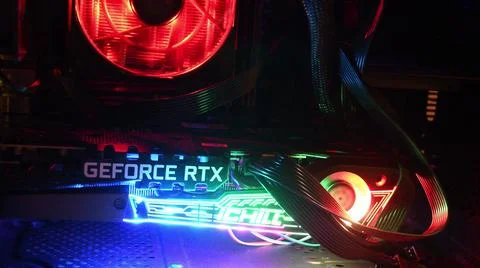 Closeup NVidia GeForce RTX 3080 inside gaming PC tower with colorful backlights Stock-Fotos