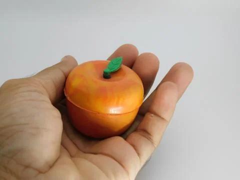 Closeup of an object(Apple model)over the human palm isolated on white backgr Foto stock