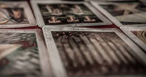Closeup of occult mystic tarot deck and old tarot cards laying on table Stock Footage 113292425