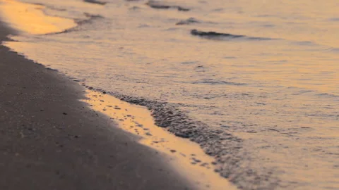 Closeup of Ocean Waves and Sand in Morning Light at Sunrise at the Beach Stock Footage 242300801