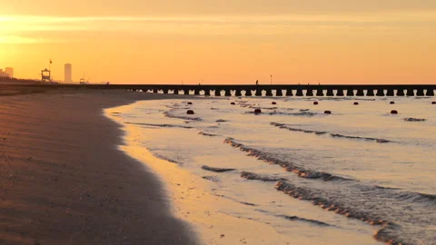 Closeup of Ocean Waves and Sand in Golden Light at Sunrise at the Beach Stock Footage 242301534