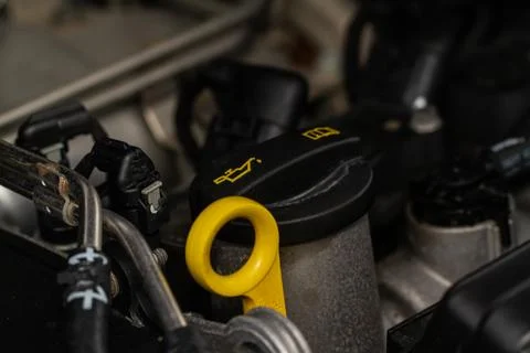 Closeup oil cap in engine room of a modern car. Oil cap on the car engine. En Stock Photos