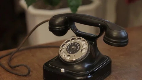 Closeup of an old black disk phone stands on an antique desk Video stock 82181289